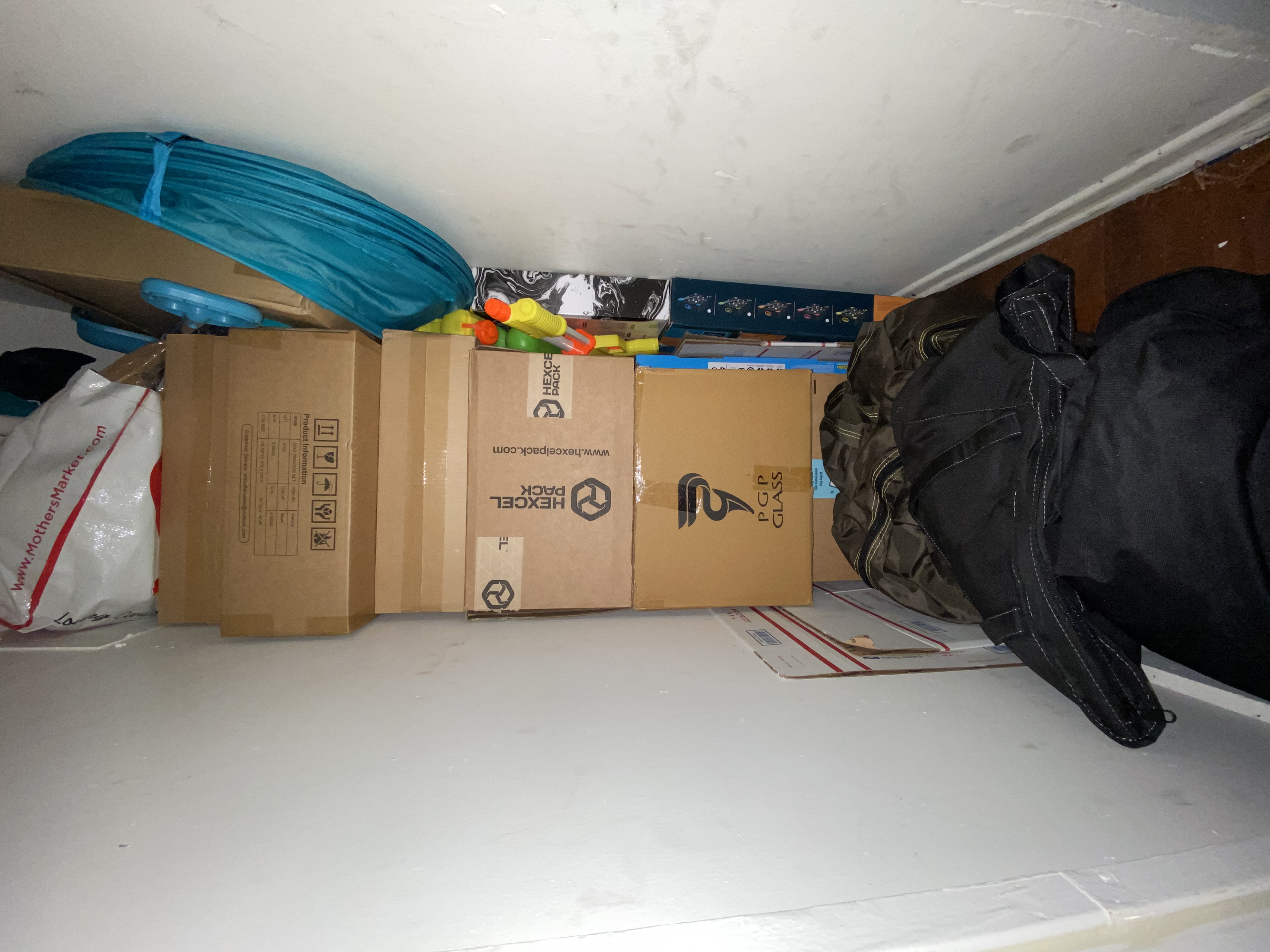 Boxes and bottles waiting in the closet — where Made With Love lived for years before it shipped.